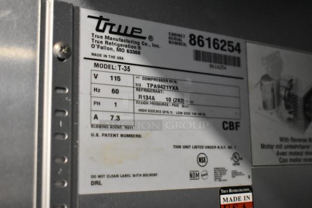 True T-35 commercial cooler label, details include 115 volts, 1 phase, poly coated racks, and R134A refrigerant. Made in USA.