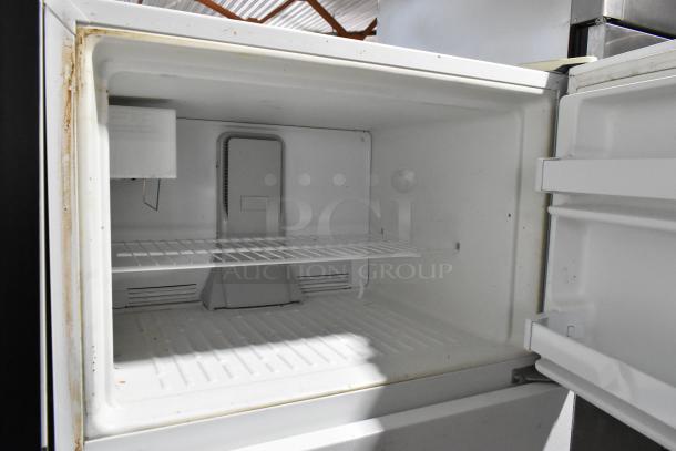 Maytag M1TXEGMYW01 cooler with freezer, 115V, 1 phase. Clean interior with shelf. Some edge wear visible.