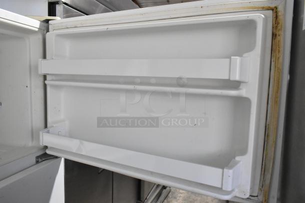 Maytag M1TXEGMYW01 metal cooler with freezer, 115 volts, 1 phase. Open door view showing interior shelves and condition.