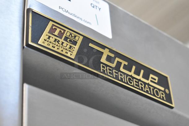 True T-35 stainless steel commercial 2-door cooler, features poly coated racks, commercial casters, True branding.