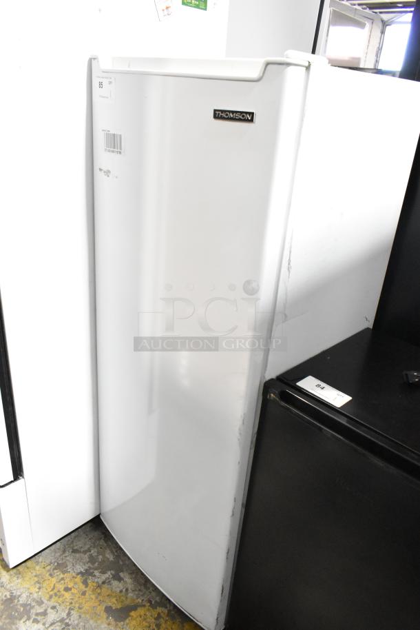 Thomson TFRF690 single door reach-in freezer, 115 volts, 1 phase. White exterior with logo, visible handle, and slight wear.
