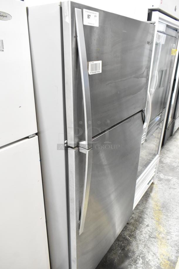 2022 Whirlpool WRT311FZDM02 stainless steel fridge with top freezer, 115V, 1 phase, visible handle and label markings.