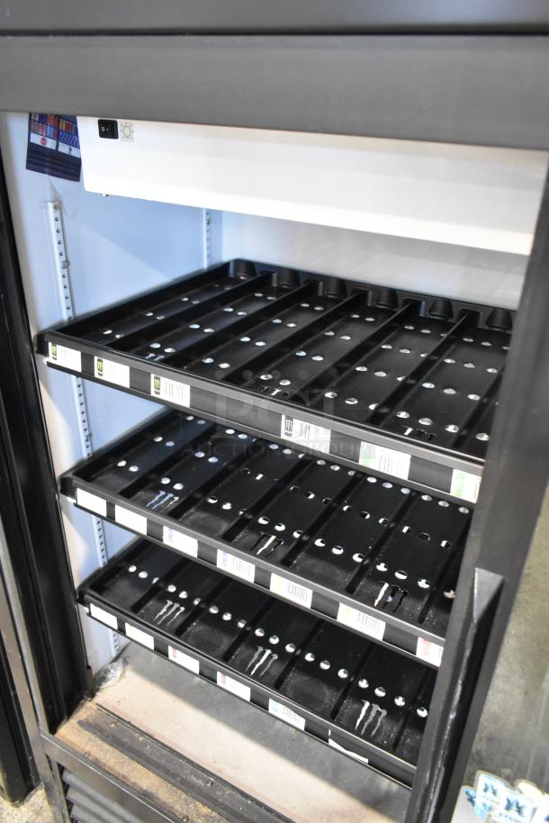 2018 True GDM-41SL-48-HC-LD 2-door cooler with poly-coated racks, 115 Volts, 1 Phase, excellent condition, metal exterior.