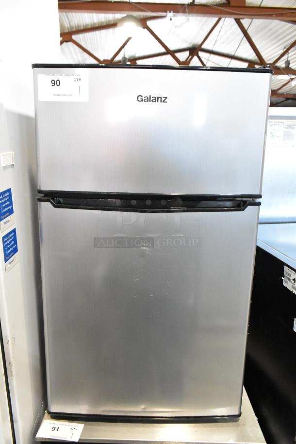 Galanz GLR31TS1E02 Mini Cooler with Freezer, stainless steel, 115V, 1 phase, visible auction tag.