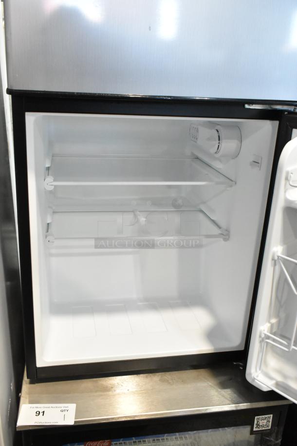 Galanz GLR31TS1E02 Mini Cooler with Freezer, 115 Volts, 1 Phase. Features adjustable shelves and thermostat.