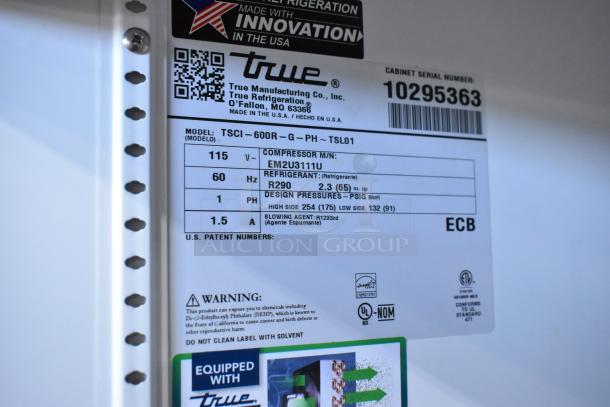 True TSCI-600R-G-PH cooler label showing specifications: 115V, 1 Phase, R290 refrigerant, made in USA. Broken glass noted.