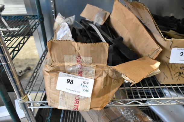 Box of 40 sharpened stainless steel knives, including a fillet knife, on a metal shelf. Marked as Lot 98, Qty Approx 40.