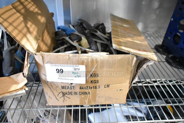 Box of approximately 40 sharpened stainless steel knives, including a fillet knife. Box labeled "Made in China," dimensions 44x23x16.5 cm.