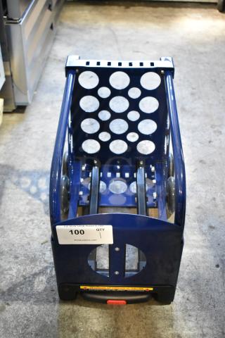 Blue metal dolly with circular cutout design, handle, and visible auction tag numbered 100 from PCI Auctions. Good condition.