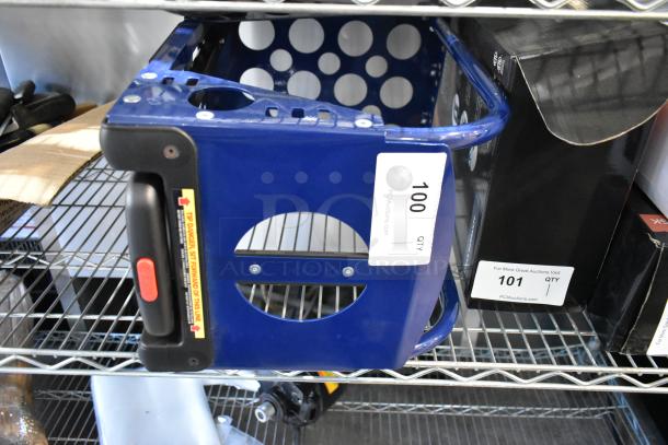 Blue metal dolly with ergonomic handle, circular cutout design, and warning label. Auction label reads "100 QTY."