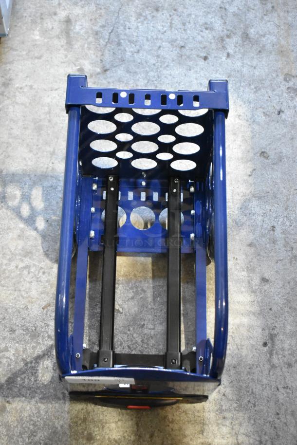Blue metal dolly with circular cutout design, sturdy frame, and black support bars, in excellent condition.