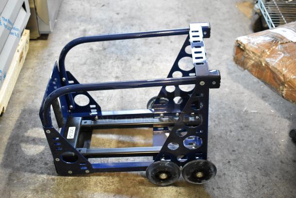 Blue metal dolly with dual wheels, circular cut-out design, and a visible label "DT0343", in excellent condition.