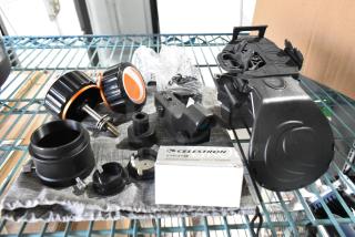 Lot of Celestron telescope components including eyepiece, mounts, knobs, and labeled box. Used condition.