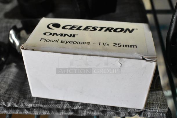 Lot of Celestron telescope accessories including a Plössl eyepiece, 1.25-inch, 25mm. Box shows wear.
