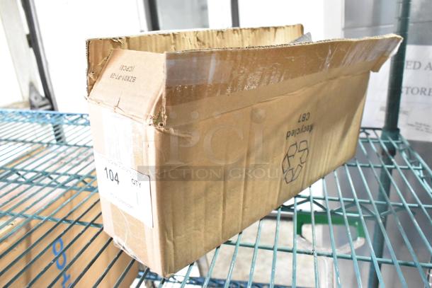 Cardboard box containing a lot of Celestron telescope accessories including an eyepiece. Box shows some wear and recycling symbol.