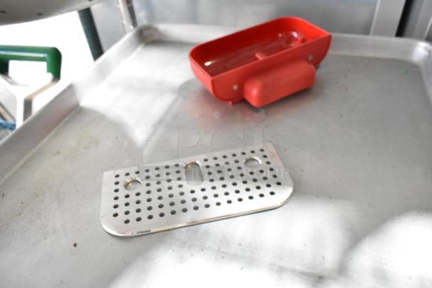 Lot of items including a metal baking pan, perforated metal plate, and red plastic container. Used condition.