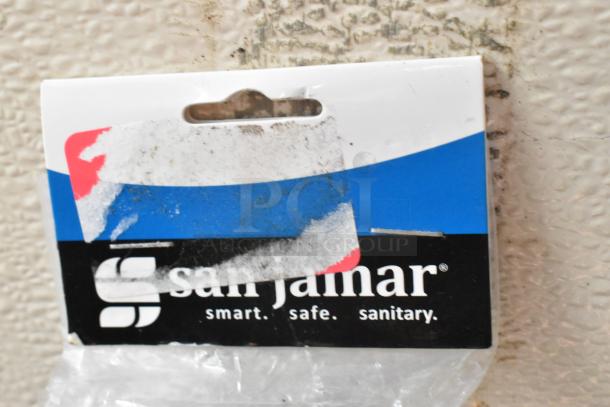 Brand new San Jamar CK6536A check holder rod, shown in packaging, with visible scratch and dent damage.