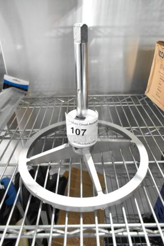 Metal Pelican Head Blade Frame in new condition, with cylindrical handle on metal rack. Auction tag "107" visible on shaft.