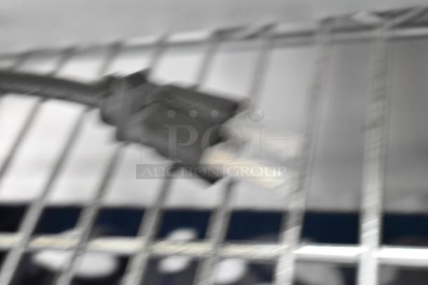 Blurry image of a power cord connected to a metal grid, likely part of the Hatco UGFF warming strip.