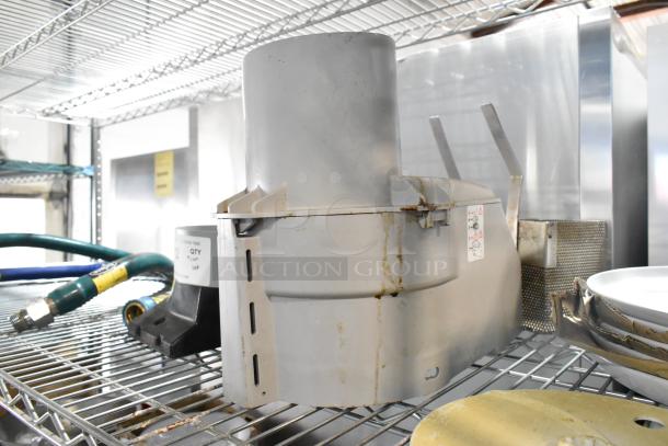 ALL ONE MONEY! mixed lot with a food processor feed head, Dormont gas hoses, and ceramic plates on metal shelves.