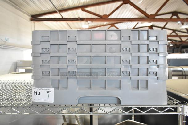 Gray poly dish rack on metal shelf, featuring a durable rectangular design with multiple slots. Auction tag reads “113.”