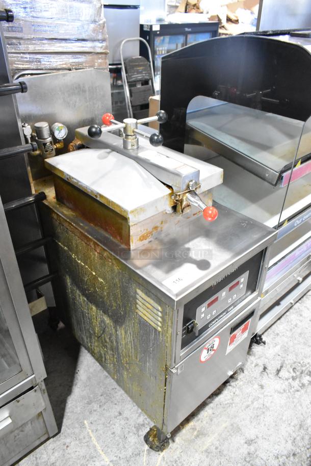 Henny Penny 600 stainless steel pressure fryer, natural gas, 80,000 BTU, on commercial casters. Used condition.