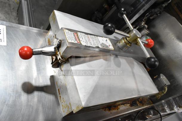 Henny Penny 600 stainless steel pressure fryer, natural gas, 80,000 BTU, on casters. Visible wear and safety label.