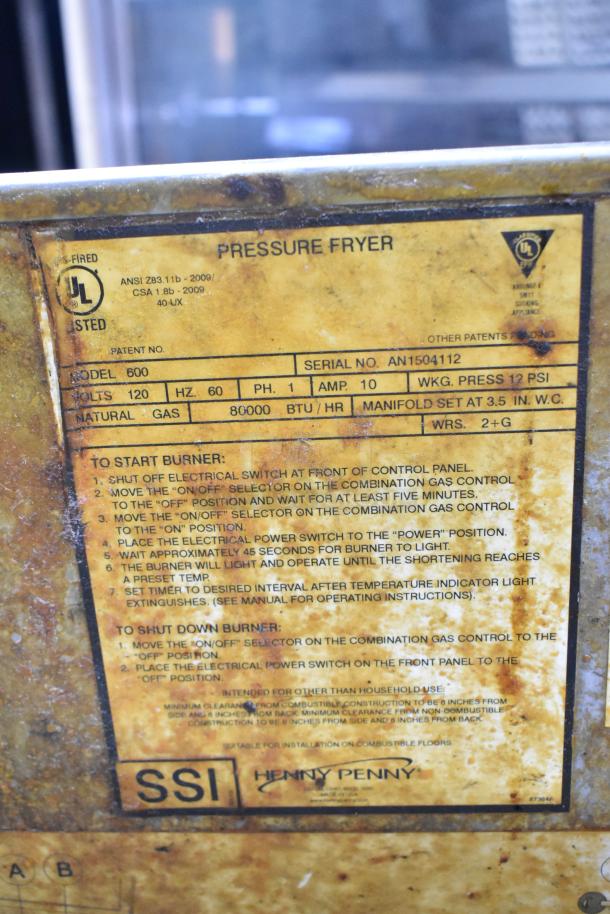 Henny Penny 600 natural gas pressure fryer, stainless steel, 80,000 BTU, on commercial casters. Visible operational label.