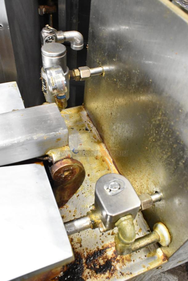 Henny Penny 600 stainless steel pressure fryer; commercial use, natural gas, 80,000 BTU, on casters, visible wear.
