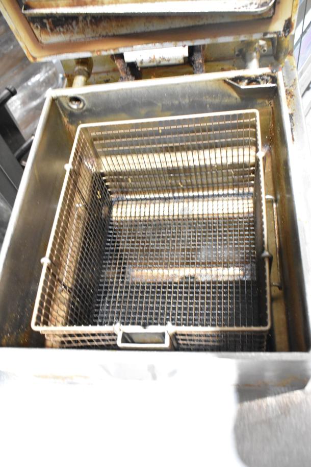 Henny Penny 600 stainless steel pressure fryer with fryer basket, natural gas, 80,000 BTU, on commercial casters.