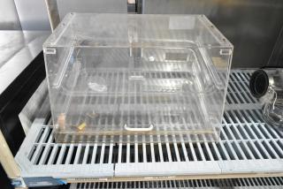 Clear poly countertop dry merchandiser case, transparent, with white handle. Used condition, ideal for displaying items.