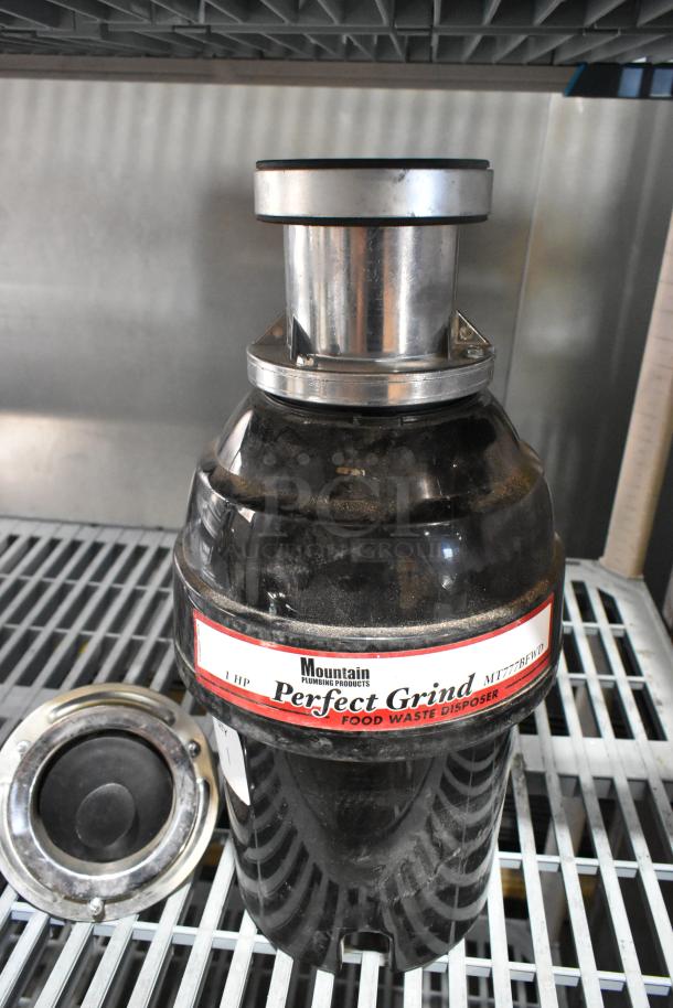 Mountain MT777BFWD Batch Feed Disposer, 1 HP, 115V, sturdy black housing, labeled "Perfect Grind."