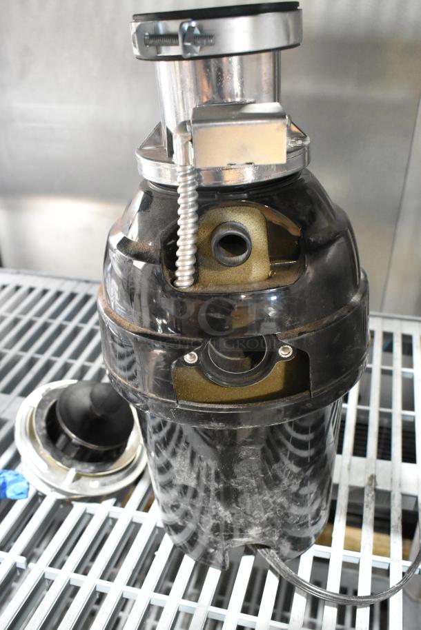 Mountain MT777BFWD Batch Feed Disposer, 115 Volts, 1 Phase. Black and metallic finish; appears in good condition.