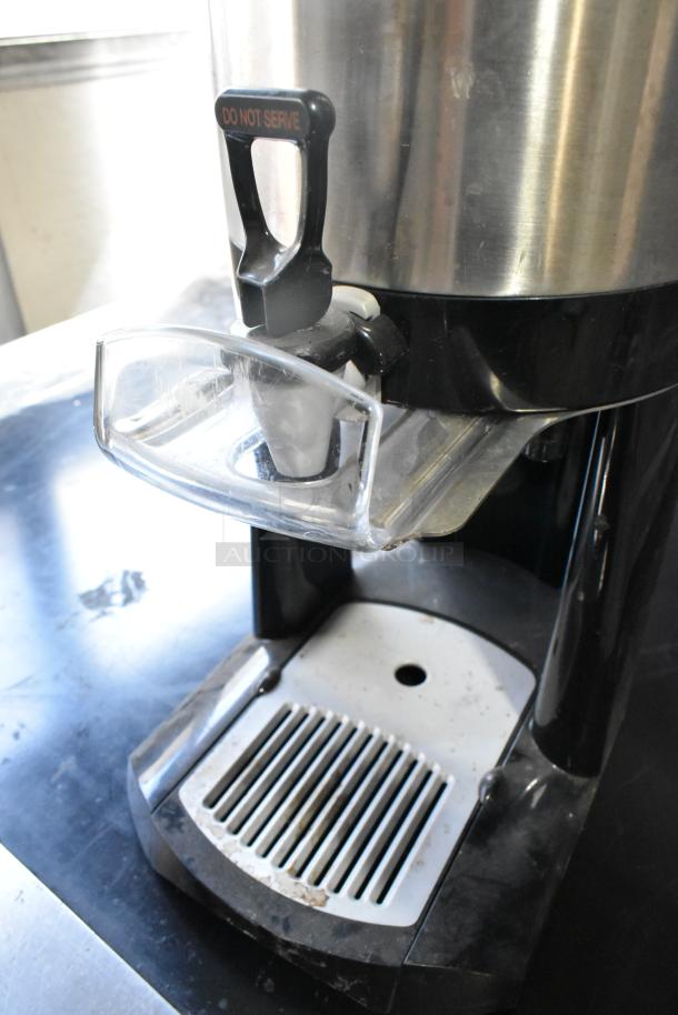 Fetco Luxus L4S-15 stainless steel beverage dispenser with "Do Not Serve" handle, in used condition.