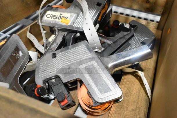 7 price guns in a wooden box, with visible labels and pricing tapes. Some wear; ideal for retail use.