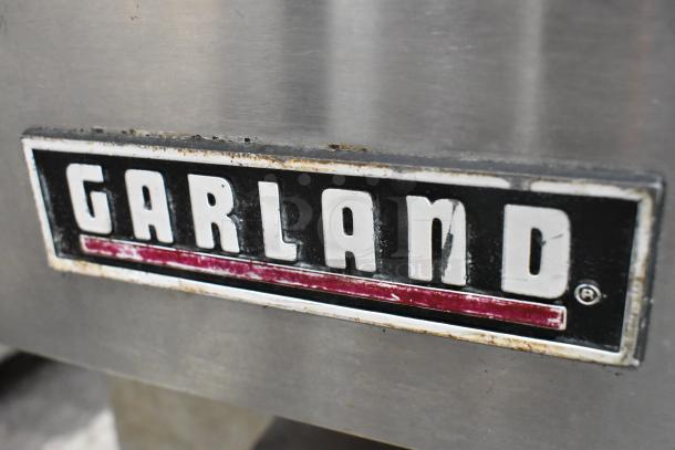 Garland logo on stainless steel surface of Master 200 Commercial Convection Oven, with visible wear.