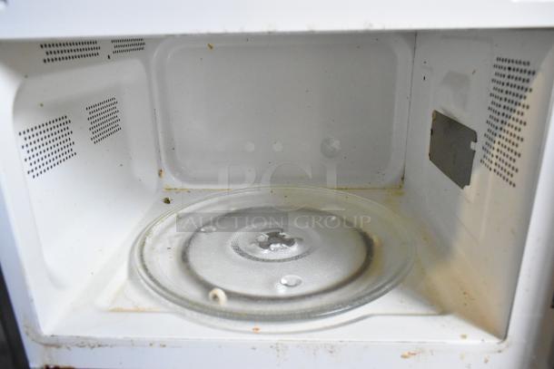 Hamilton Beach P90D23AL-WR1 microwave interior with turntable. Shows signs of use and wear. 120V, 1 phase.