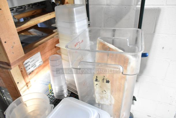 Two-tier lot with poly bins, cutting boards, and fry baskets on a wooden shelf. Items in used condition.