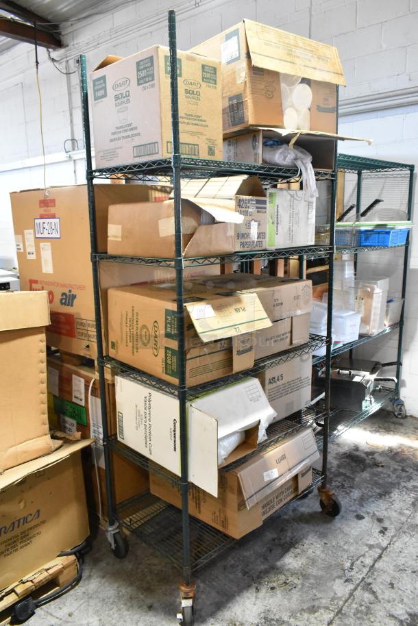 Various boxes on shelves with Dart P400N portion cups, 9" lids, Companions PET cup lids, and uncoated paper plates.