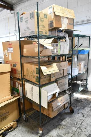 Various boxes on shelves with Dart P400N portion cups, 9" lids, Companions PET cup lids, and uncoated paper plates.