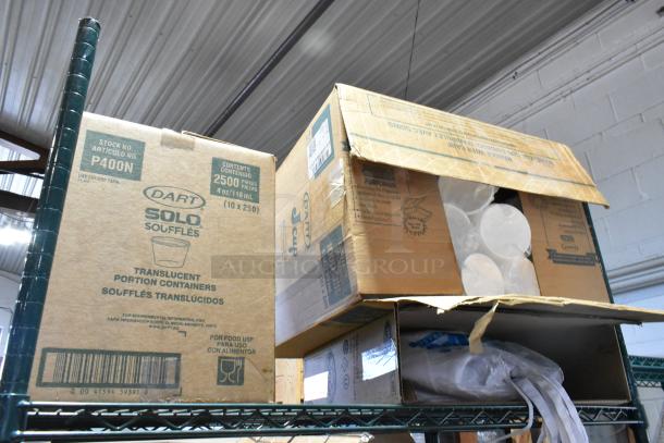 Metro Lot of Dart P400N portion cups, plastic lids, clear PET cup lids, and uncoated paper plates in boxes.