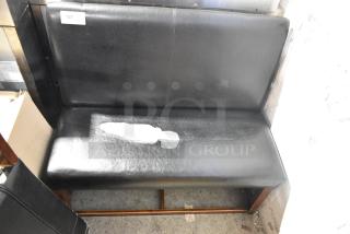 Two black single-sided booth seats with leather-like material, visible wear and tear, numbered tag "137."