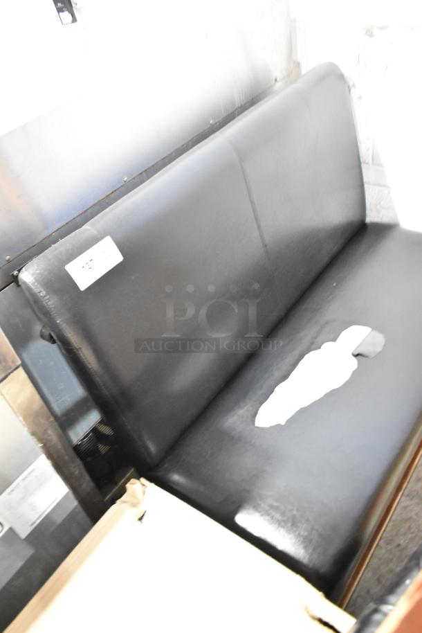 Two black single-sided booth seats, one with visible tear. Auction label "137" attached. Used condition.