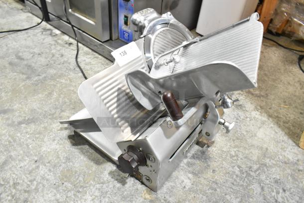Globe 660 metal commercial countertop meat slicer, features blade sharpener, 115 volts, 1 phase. Appears in good condition.