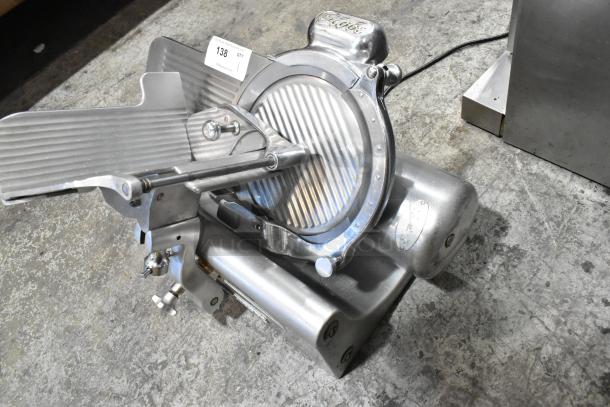 Globe 660 metal countertop meat slicer with blade sharpener, 115 volts, 1 phase; in good condition, visible branding and labels.