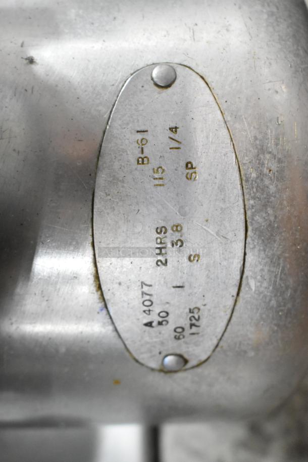 Globe 660 metal commercial countertop meat slicer with blade sharpener. Features 115 volts, 1 phase. Close-up of label.