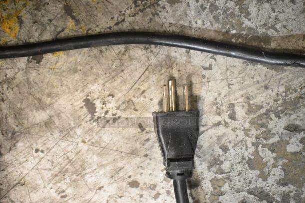 Primo 601141 water cooler base plug, black, on a scratched metal surface. 115 volts, single phase.