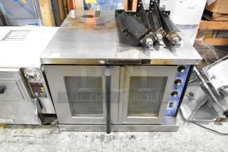 Bakers Pride Cyclone stainless steel commercial convection oven with view-through doors, metal racks, controls, and legs.
