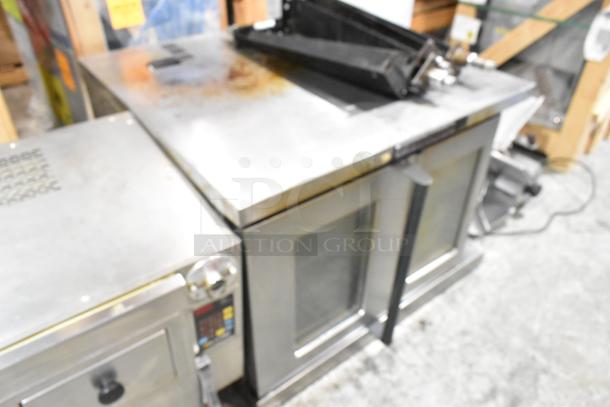 Bakers Pride Cyclone stainless steel convection oven, view-through doors, metal racks, thermostatic controls, metal legs.