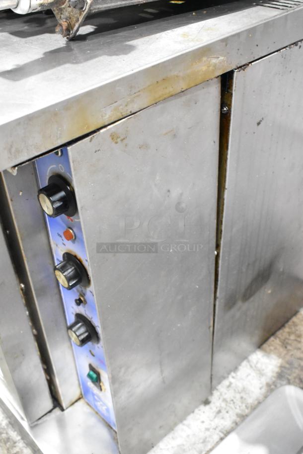 Bakers Pride Cyclone stainless steel convection oven with view-through doors, thermostatic controls, and metal legs. Some wear visible.